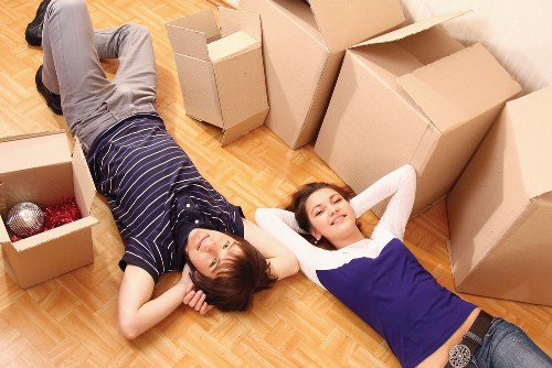 Professional movers handling flat removals in a Deptford stairwell
